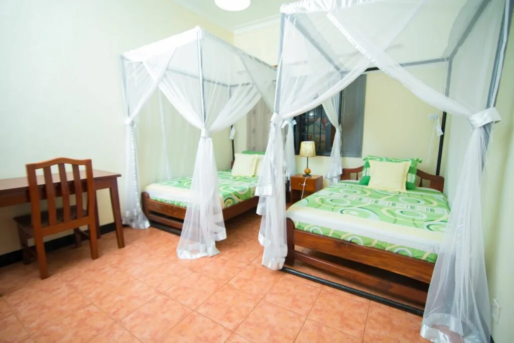 A twin room fitted with mosquito nets, ideal for friends travelling together