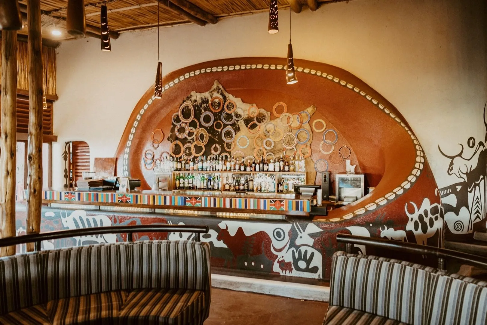The lodge's circular bar and lounge, decorated with traditional Maasai artwork and beadwork.