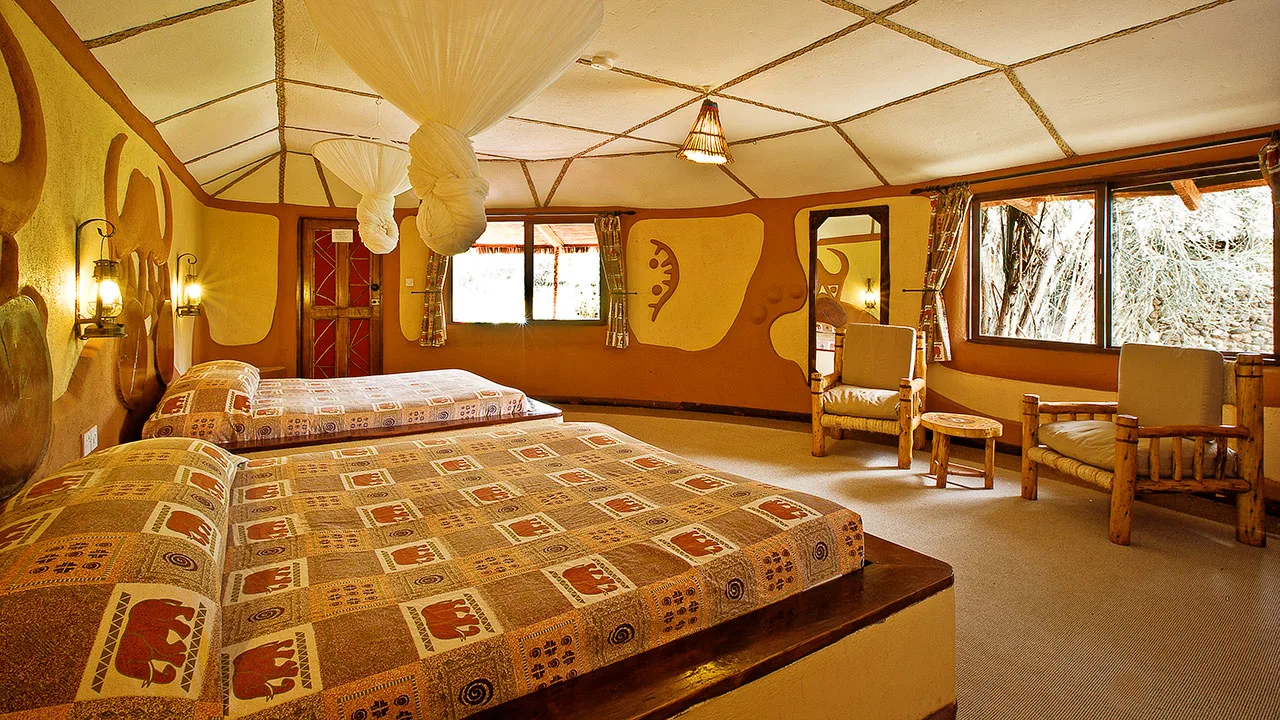 Spacious twin room with traditional African decor and mosquito netting