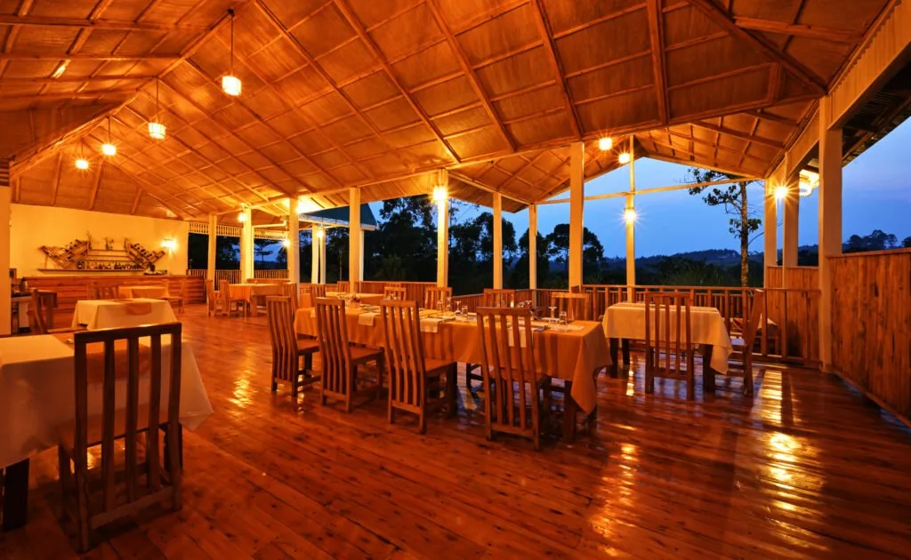 The hilltop restaurant sets a candlelit table over the forest canopy.