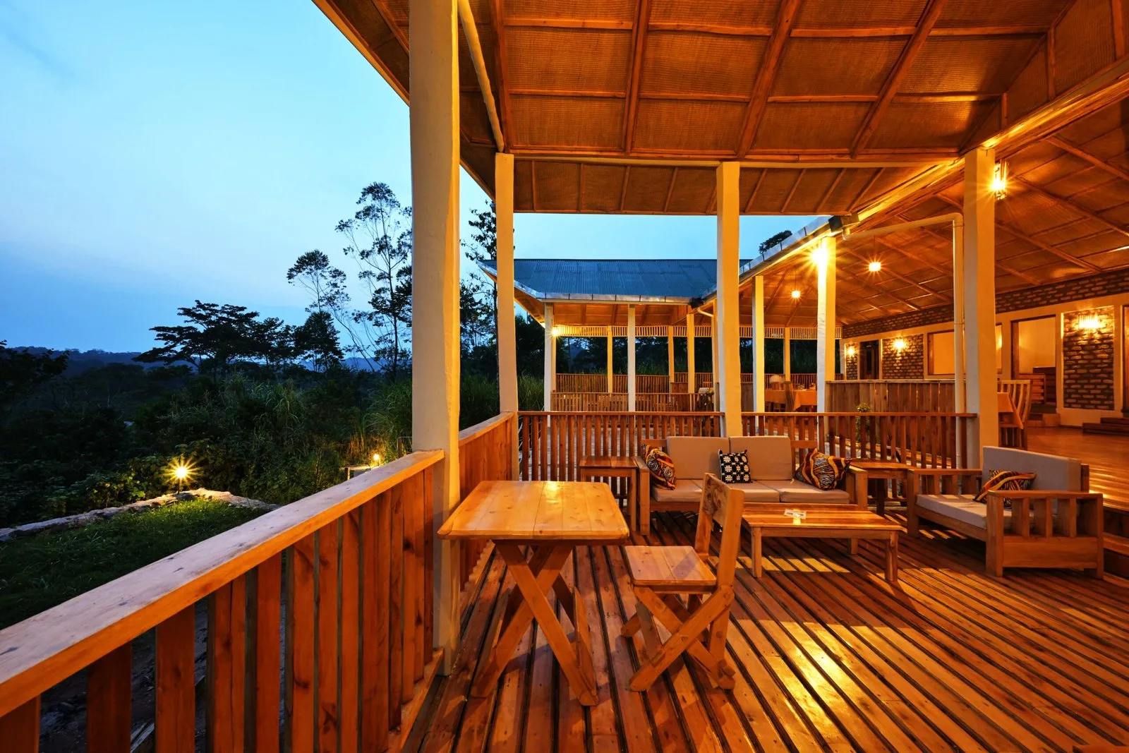 A quiet lounge deck for evening drinks with forest views.