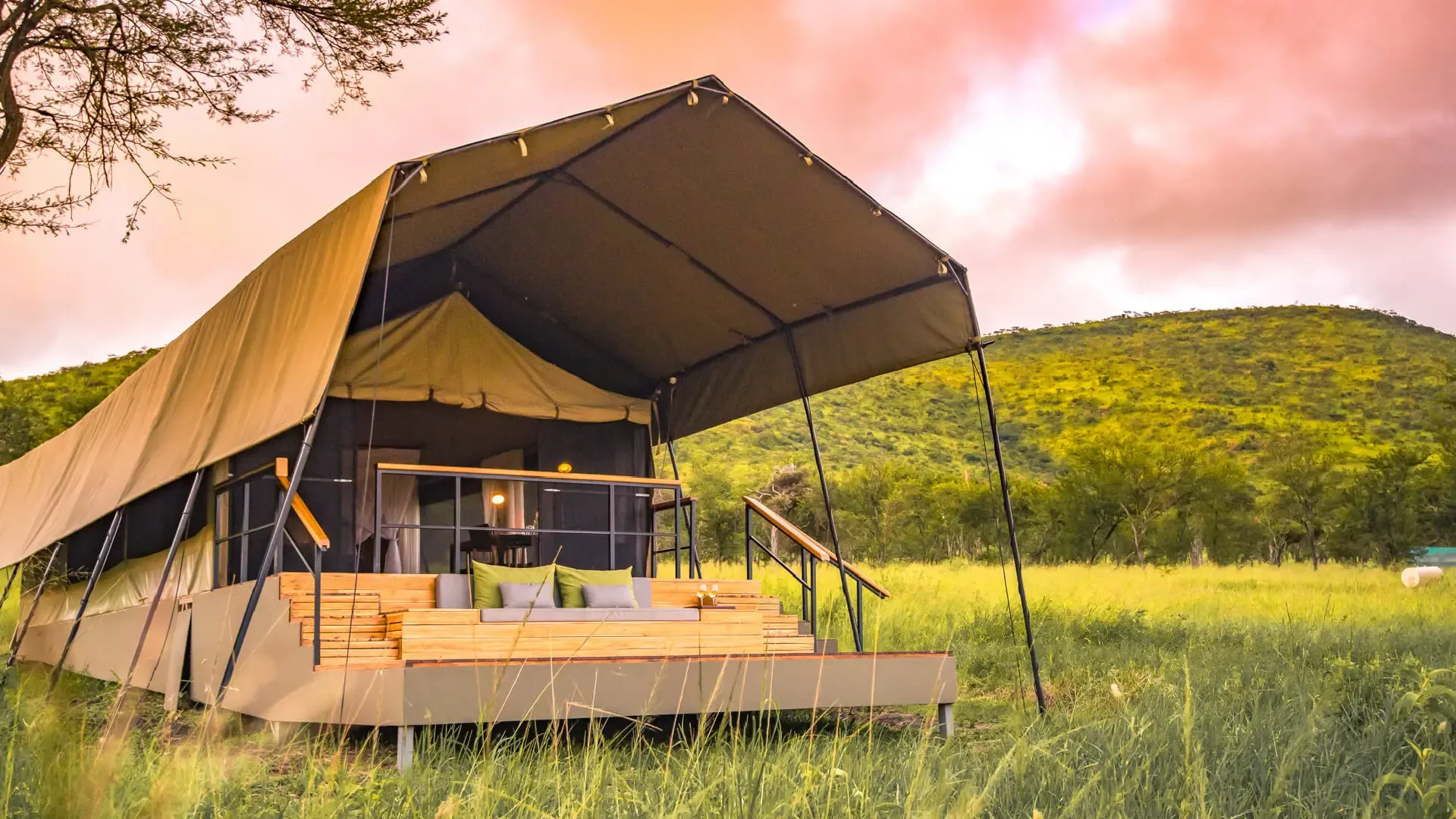 One of Dunia's raised guest tents catching the last light over the plains.