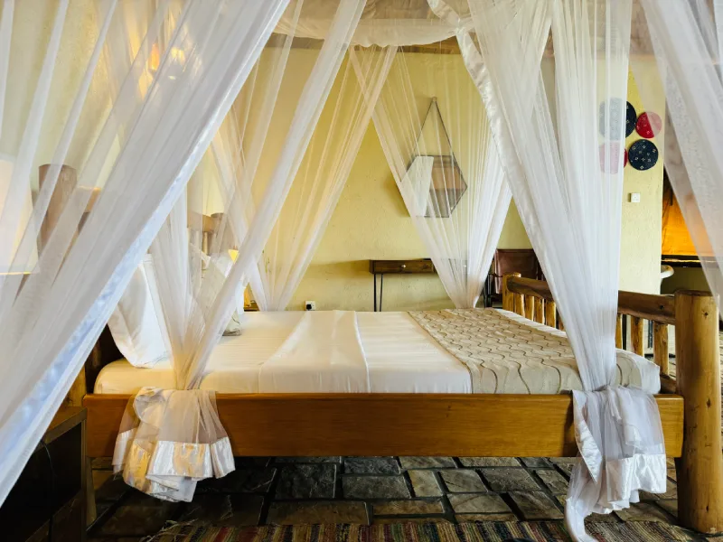 Spacious cottage bedroom with a romantic mosquito-net canopy