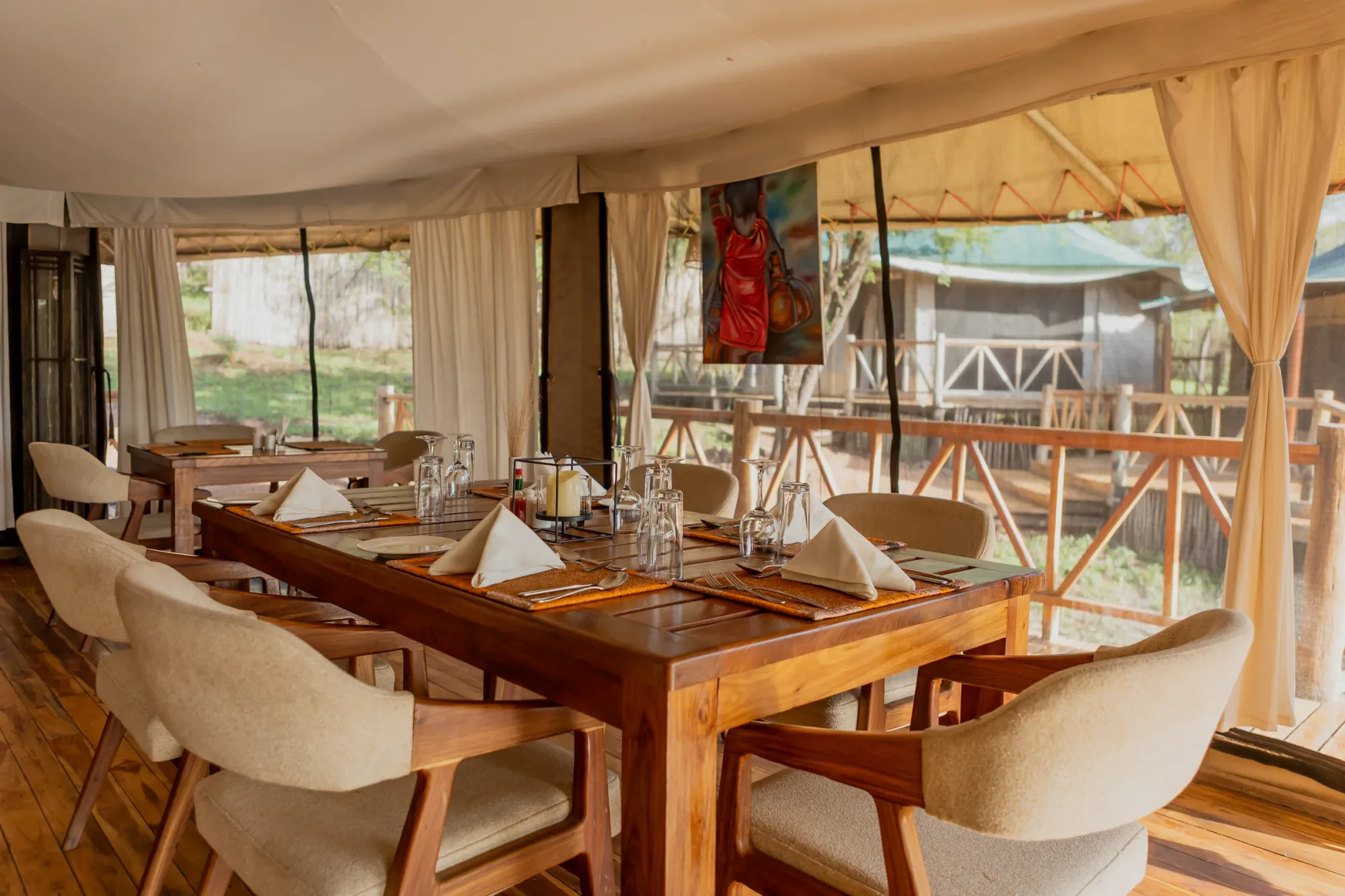 The open-sided dining tent seats guests together for meals under canvas.