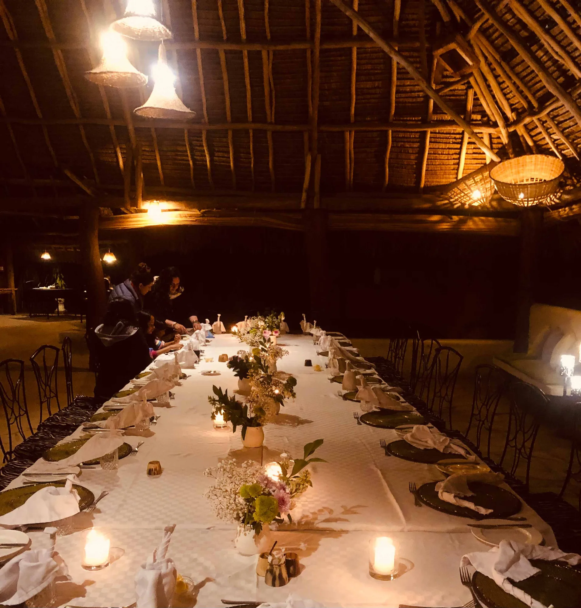 An al fresco candlelit dinner setting under the stars