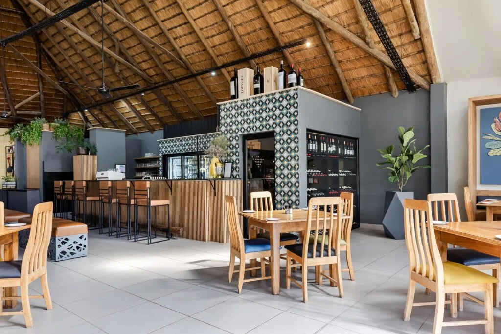 Indoor/outdoor dining at the estate's restaurant, overlooking the gardens and river.
