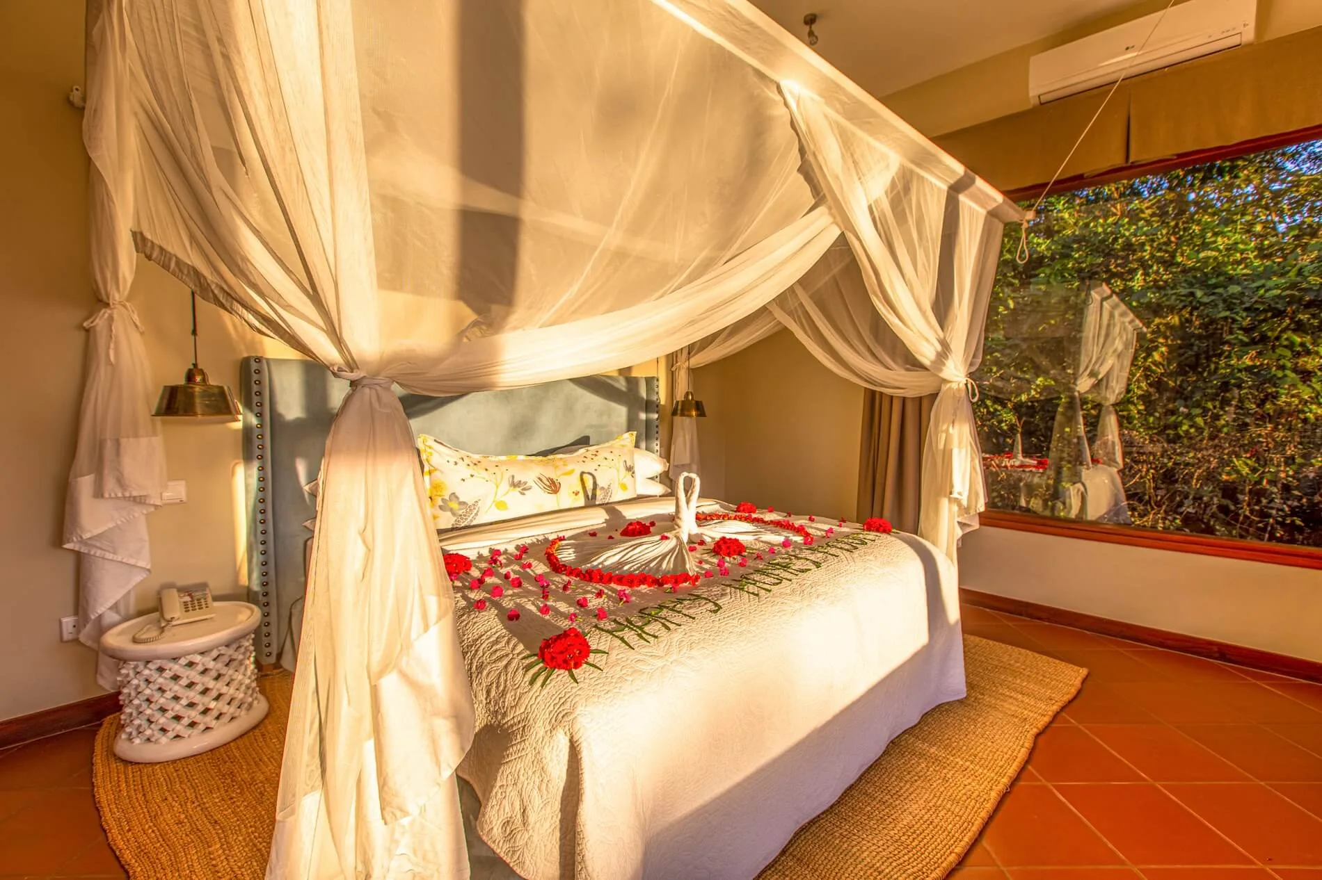 A canopy-draped suite dressed for a special occasion.