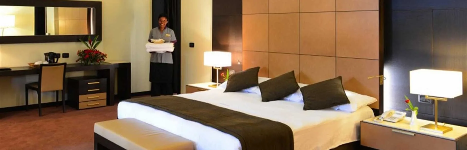 A well-appointed guest room, turned down by housekeeping