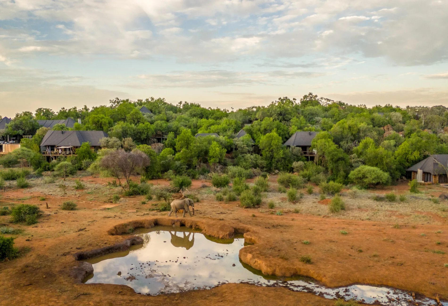 Hillside lodge and wildlife waterhole