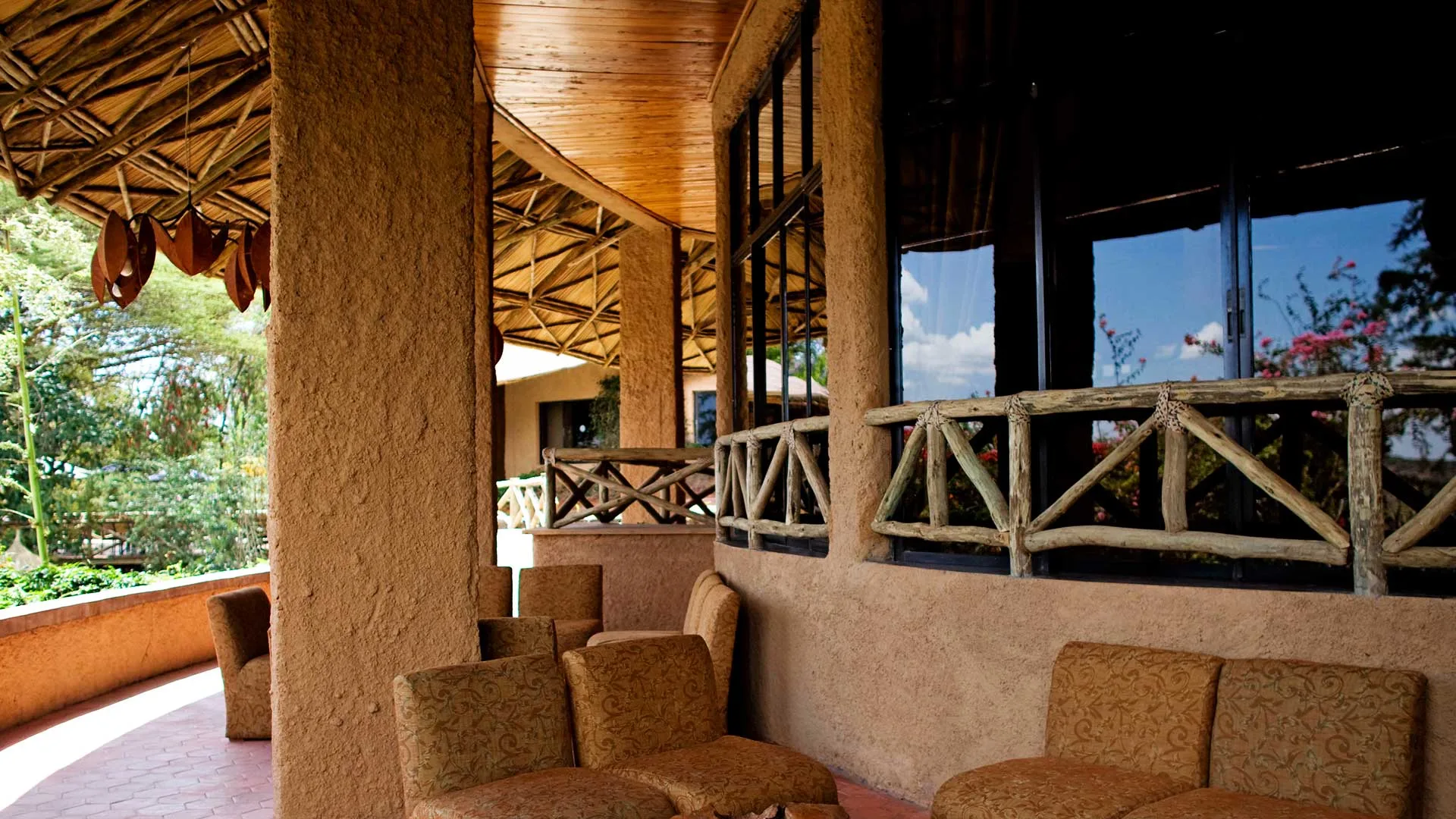 Traditional round-house architecture with thatched roofs and hand-built stonework runs throughout the lodge.