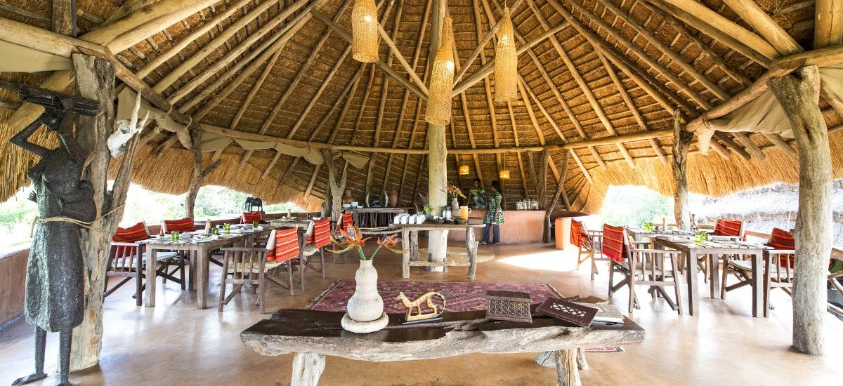 The open-sided dining banda serves meals with views out over the bush.