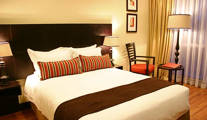 Air-conditioned rooms pair contemporary furnishings with warm African-inspired accents.