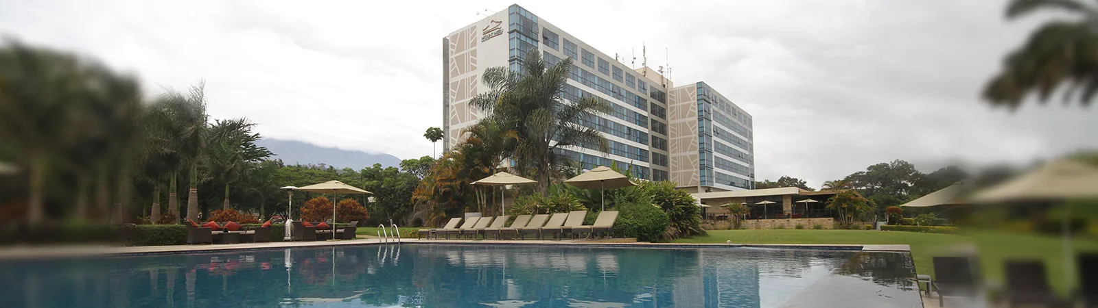 The pool deck opens onto an uninterrupted view of Mount Meru itself.