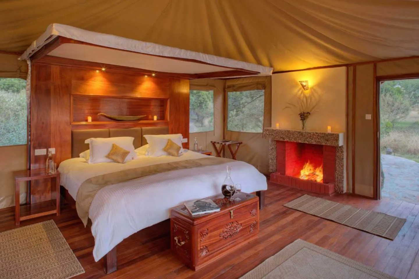 Guest tents feature a canopy bed and wood-burning fireplace for cool Mara evenings.