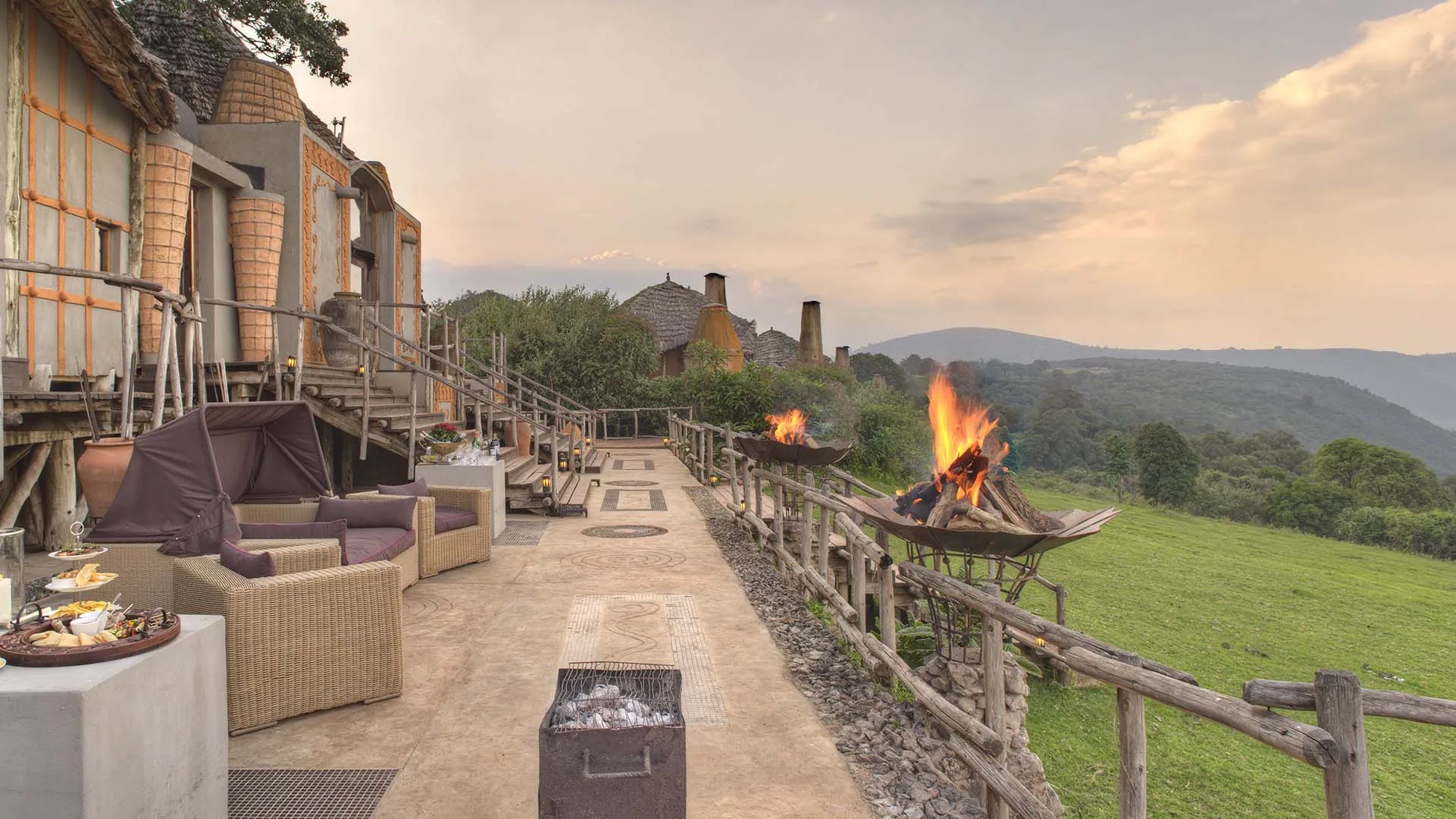 Opulent, chandelier-lit camp architecture is set among indigenous forest on the crater rim.