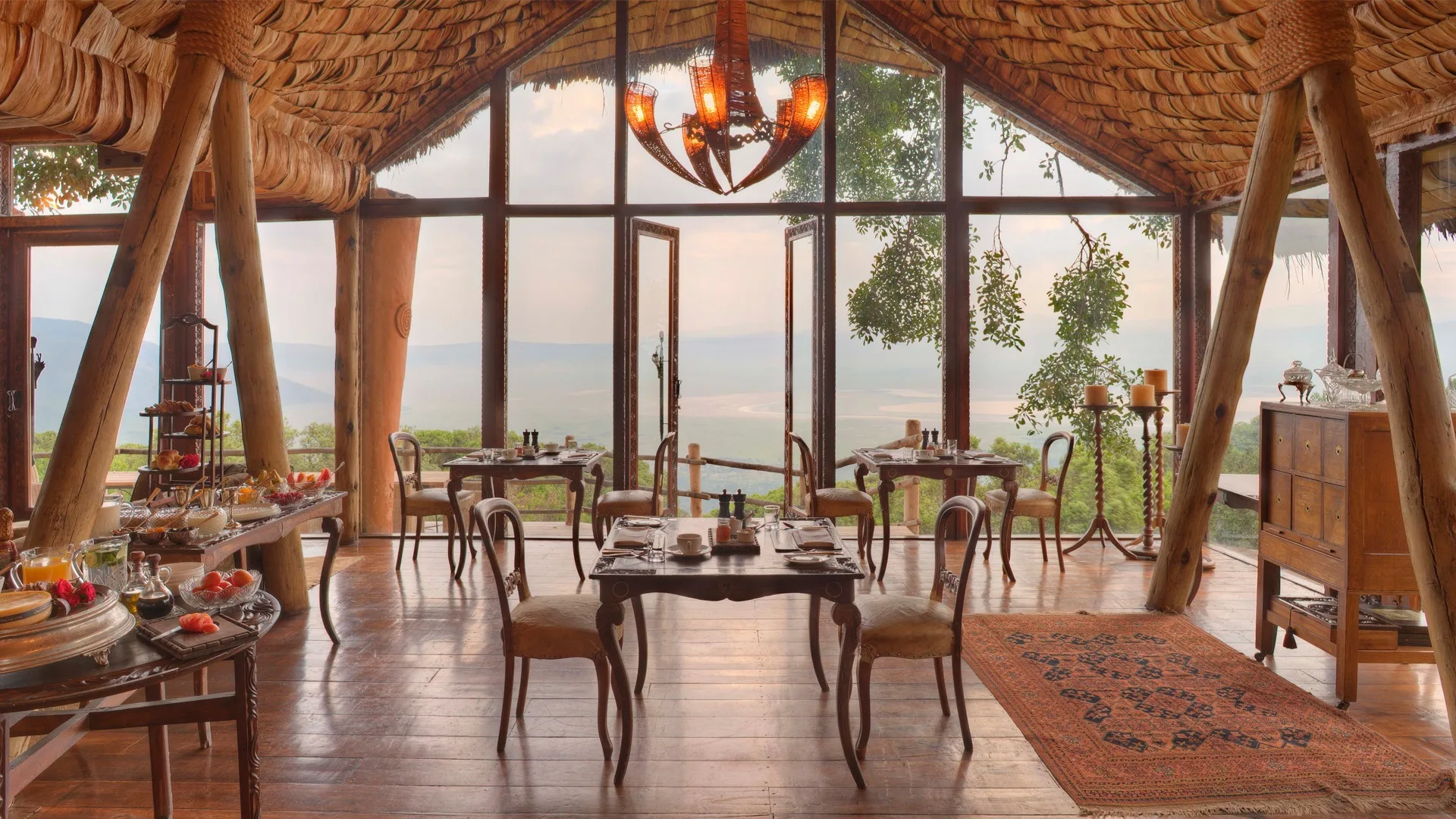 The dining area's handcrafted, banana-leaf thatched ceiling reflects the lodge's opulent design.