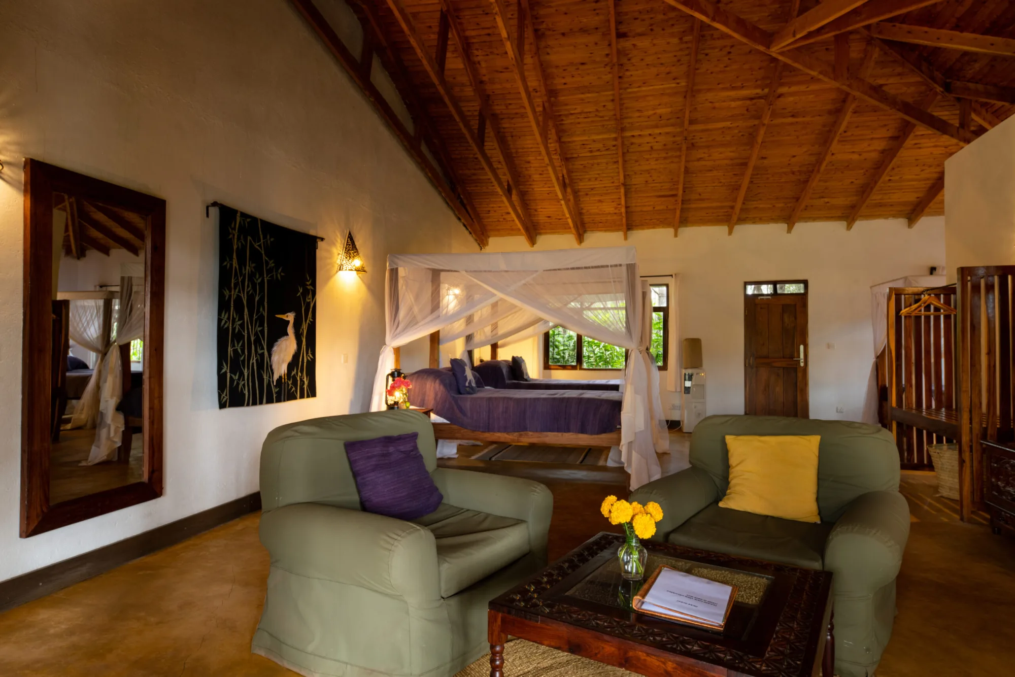 Suite rooms pair colonial-farmhouse styling with modern comforts like canopy beds and a private sitting area.
