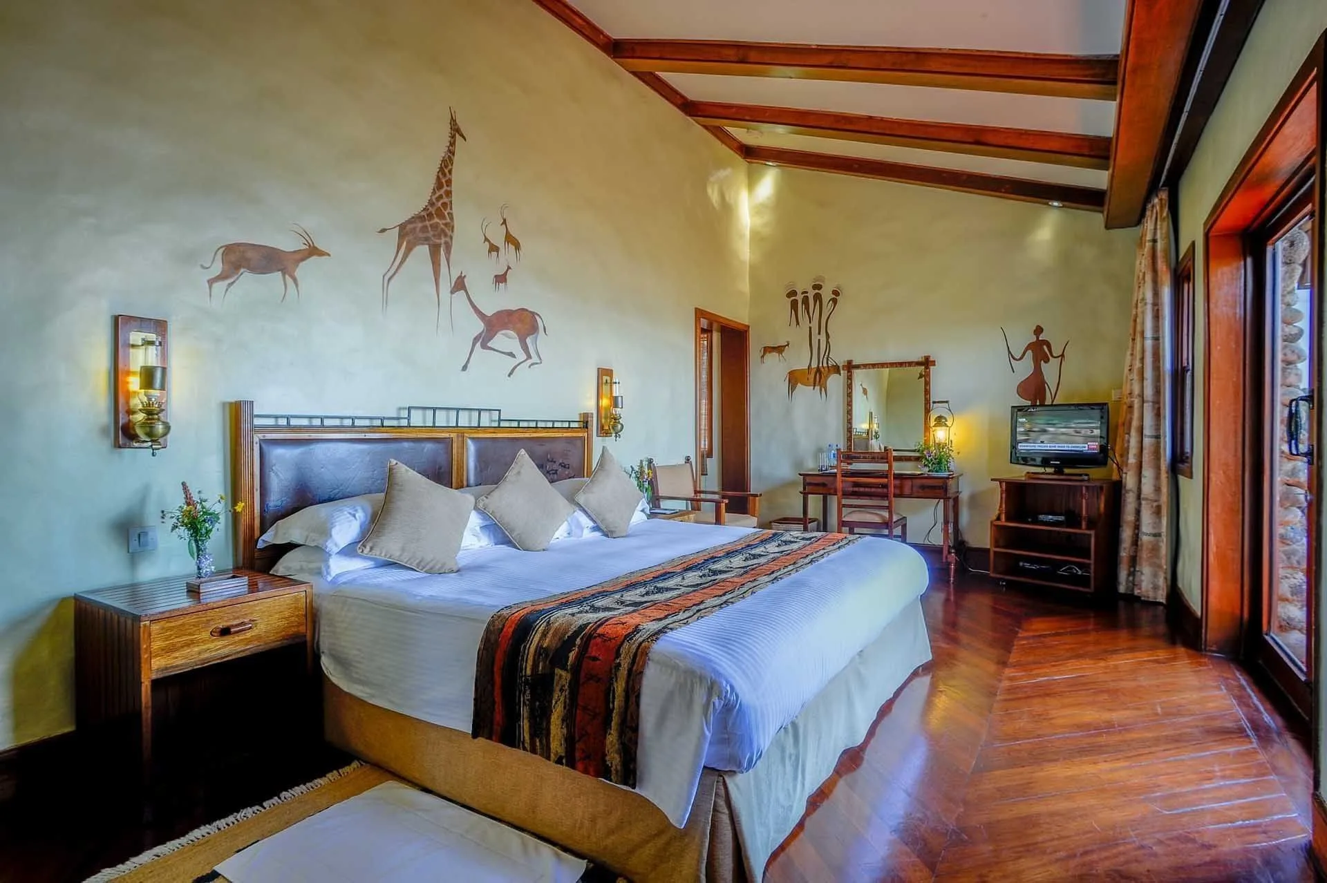 Guest rooms feature locally inspired decor, tribal-patterned textiles, and private stone balconies.