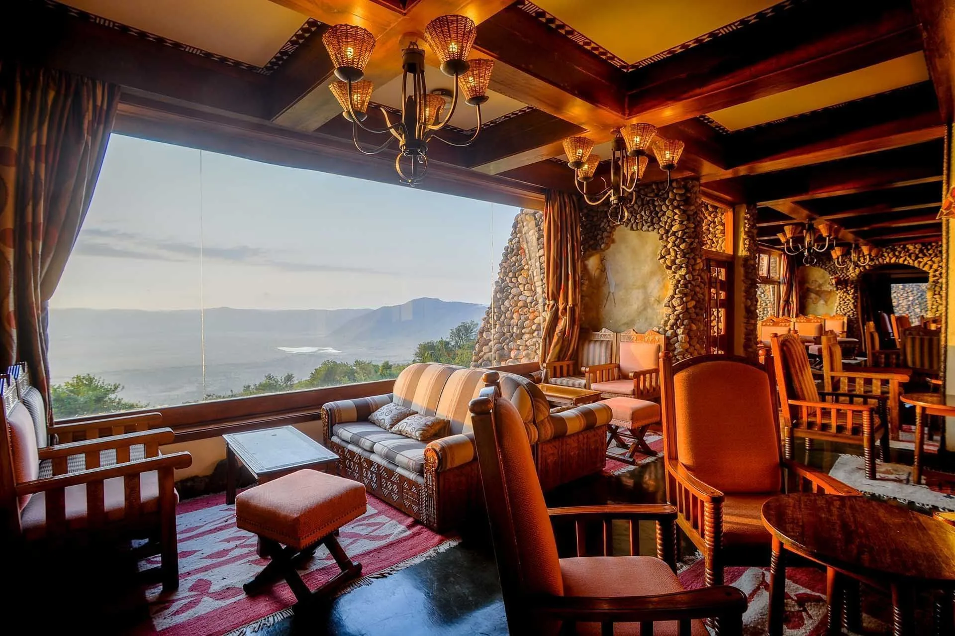 The bar lounge pairs Tanzanian craft decor with sweeping views into the crater.