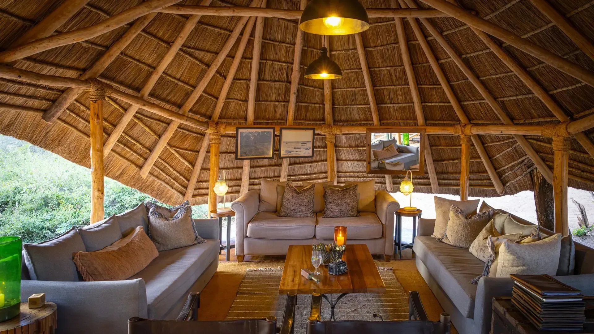 The camp's cozy, circular thatched lounge, ideal for relaxing between game drives.