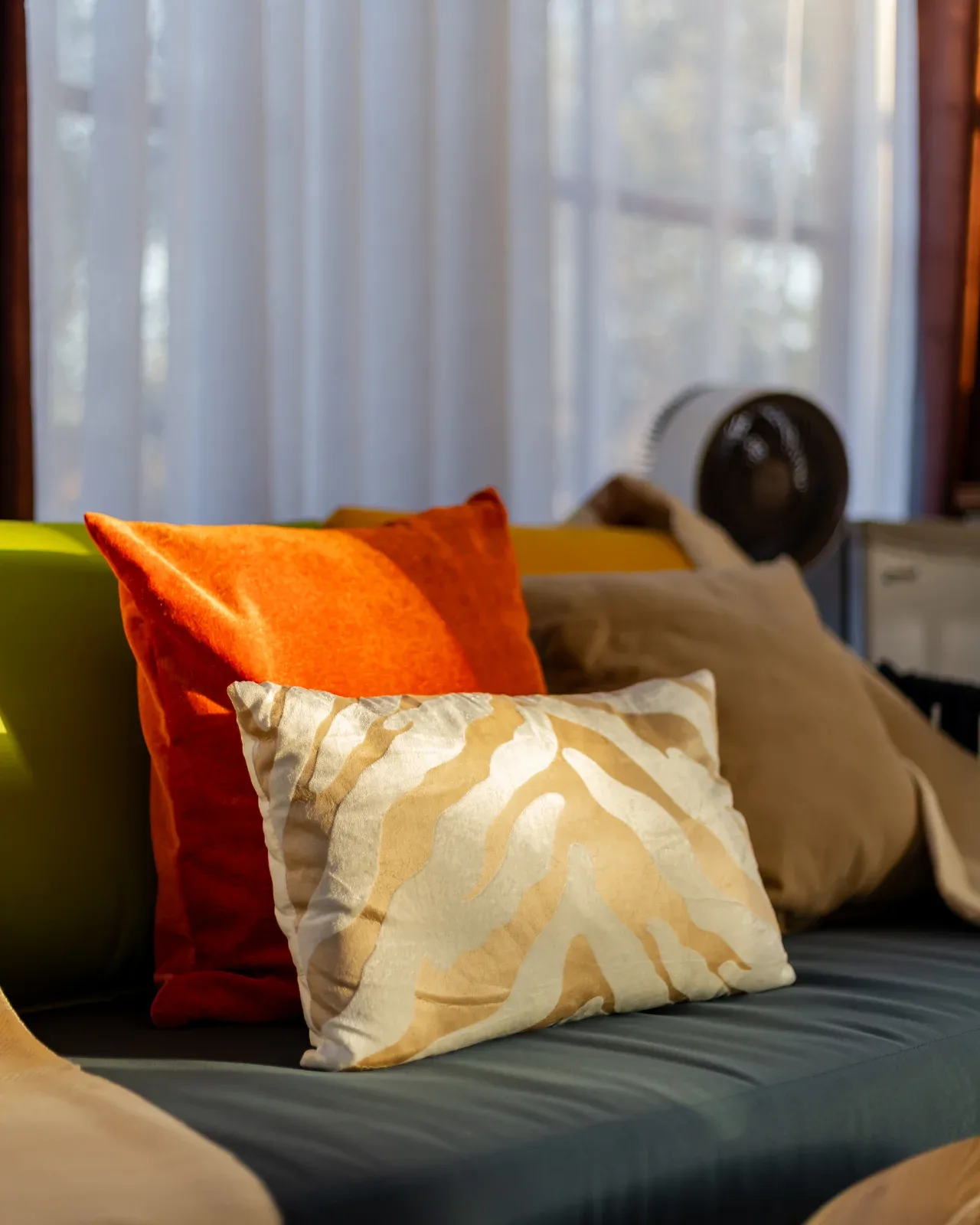 Relaxed lounge seating in the main area, styled with African-print cushions.