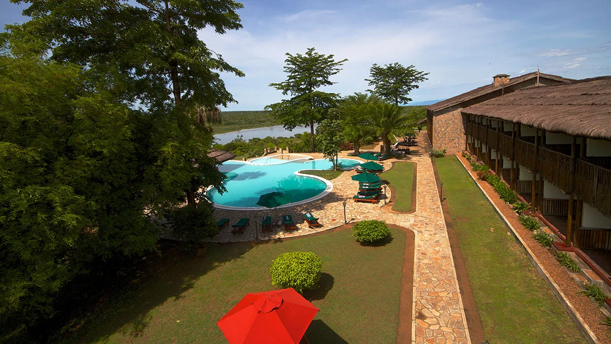 The lodge sits on a bluff above the Nile, with gardens running down to the pool.
