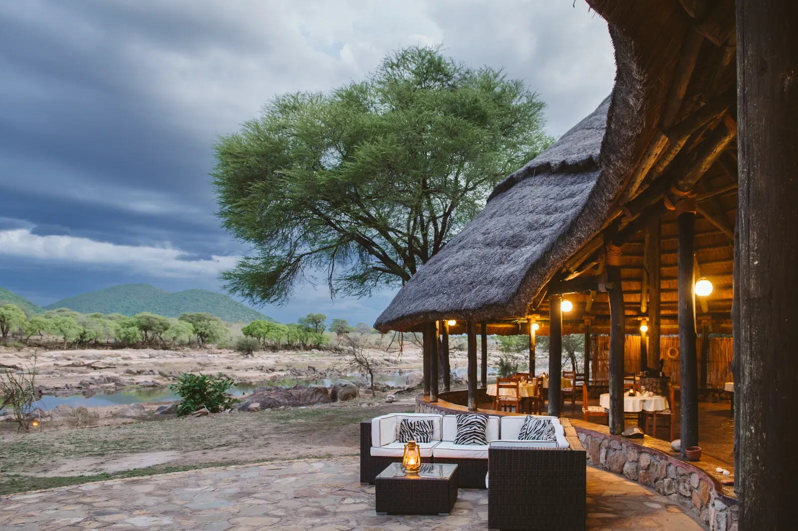 Riverside banda beneath acacia trees