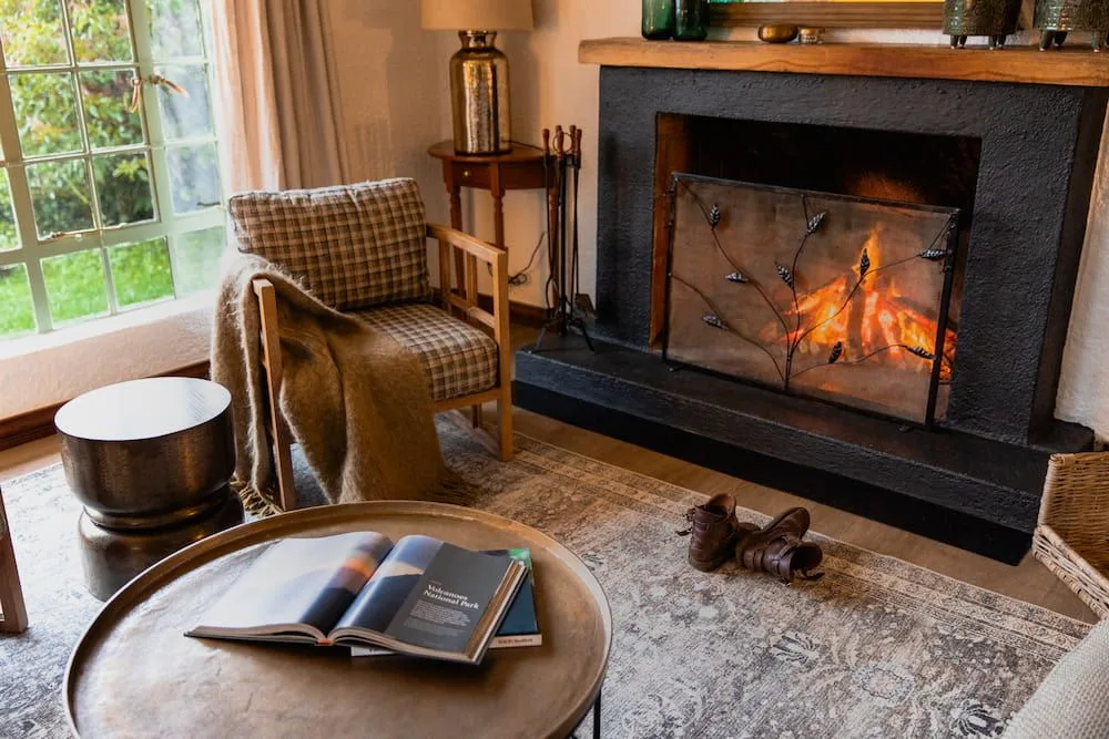 A cottage sitting area with a wood fire lit against the cool mountain evenings.