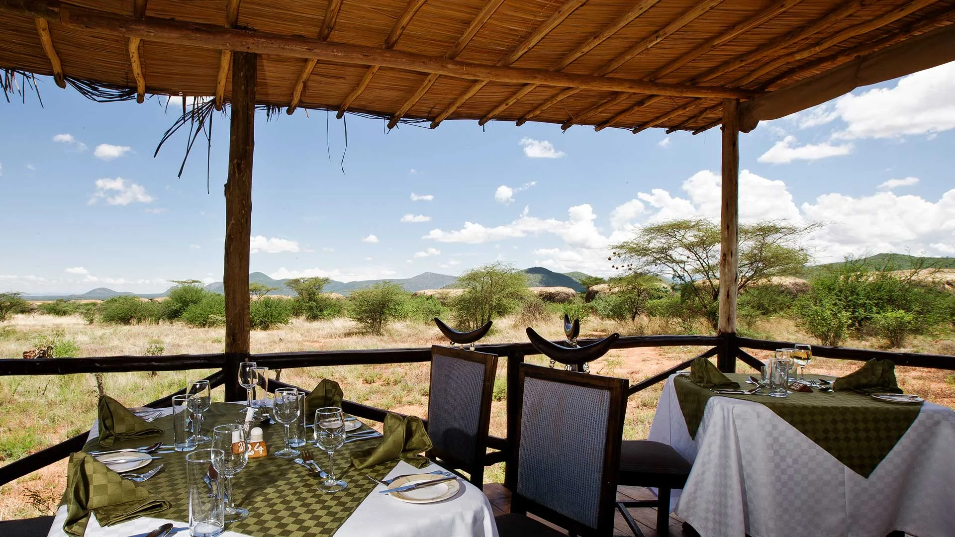 Meals are served under a thatched pavilion with sweeping views across Samburu National Reserve.