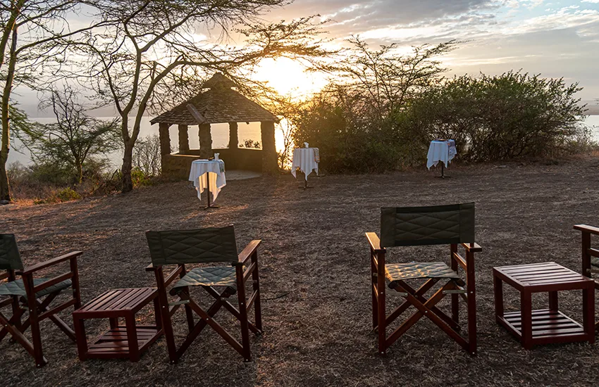 Sundowners at a viewpoint overlooking Lake Nakuru's flamingo-lined shores.