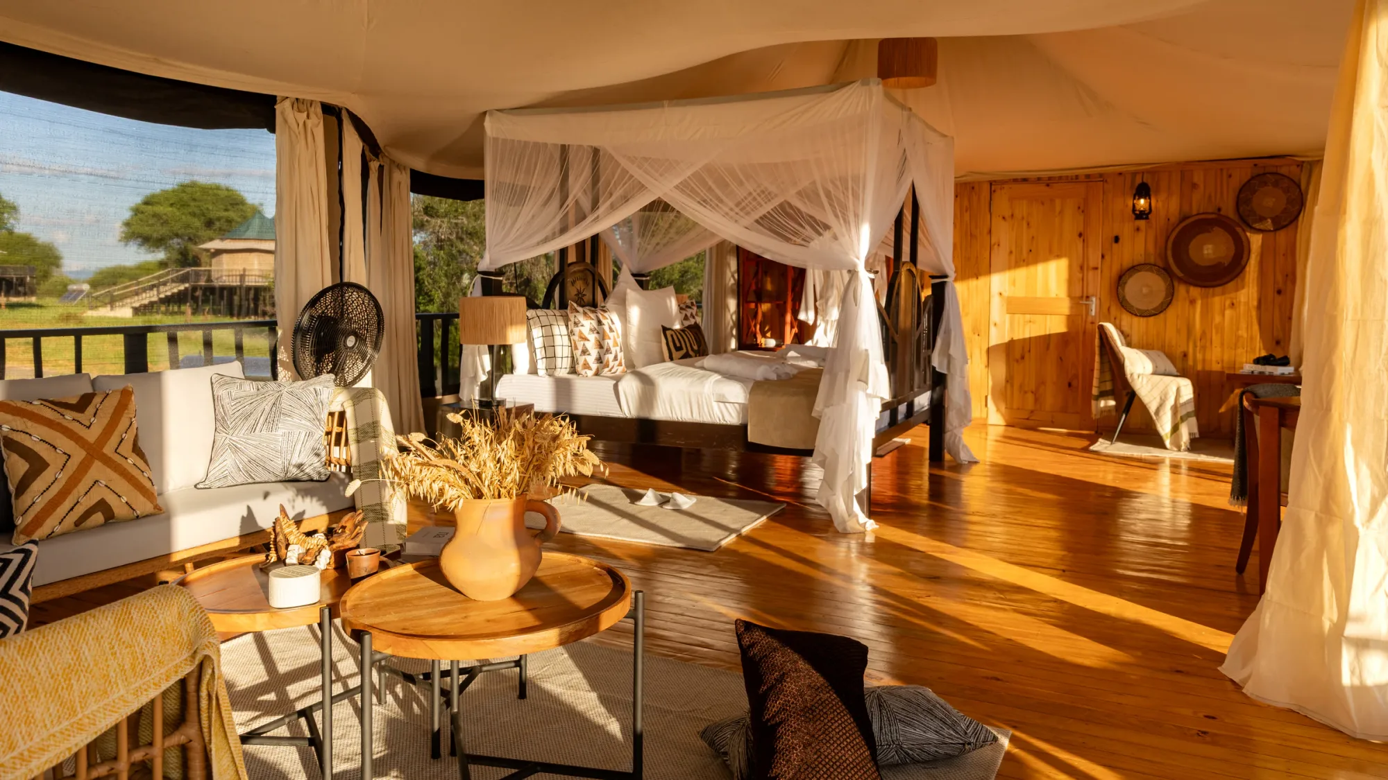 Guest tents pair canopy beds with sweeping views over the surrounding bush.