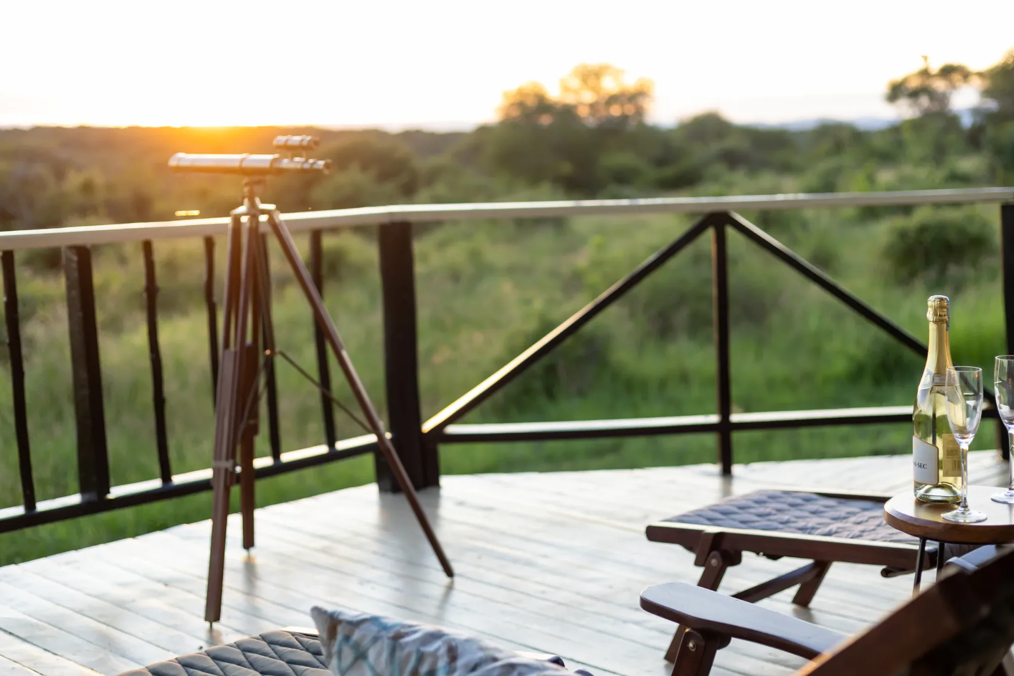 Guests unwind on private deck loungers as the sun sets over Tarangire.