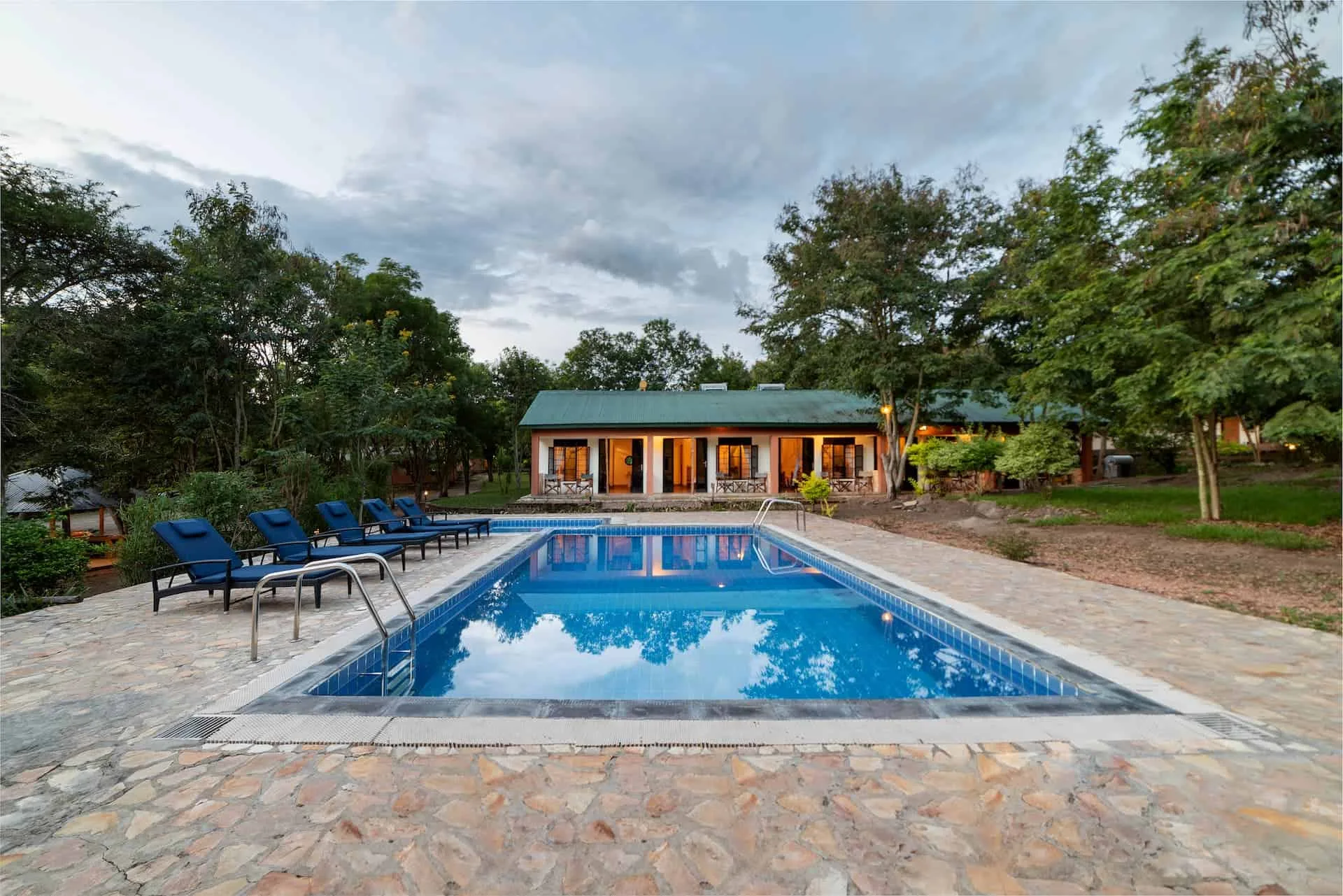 Poolside at Simba Safari Camp as evening lights come on