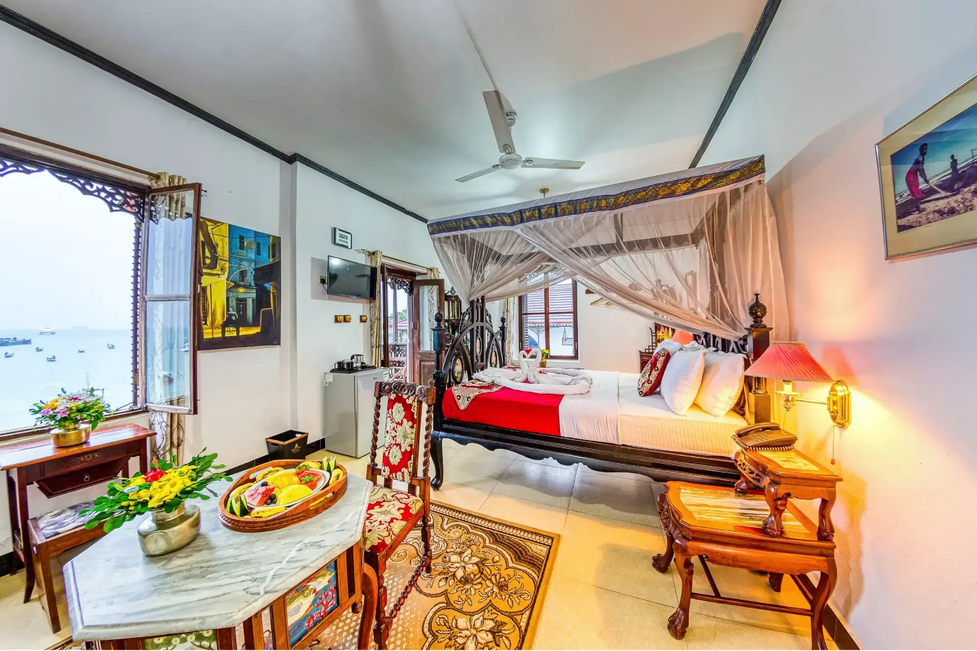 Suites look out over the Indian Ocean through traditional carved Zanzibari windows.