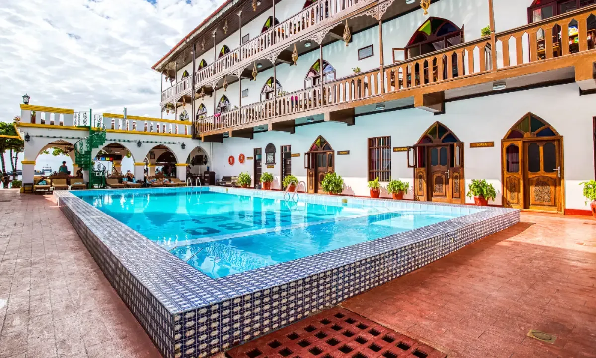 A second courtyard pool sits beneath the hotel's original Zanzibari balconies.