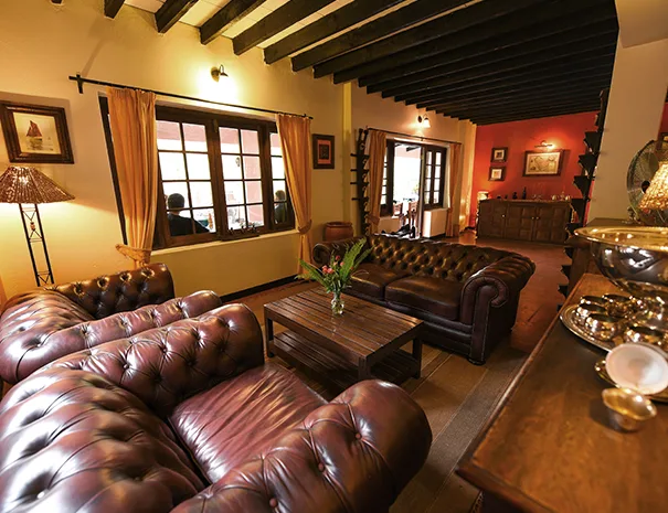 The hotel's colonial-style lounge, furnished with leather chesterfield sofas