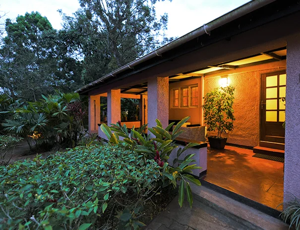 One of the hotel's guest cottages lit up as evening falls