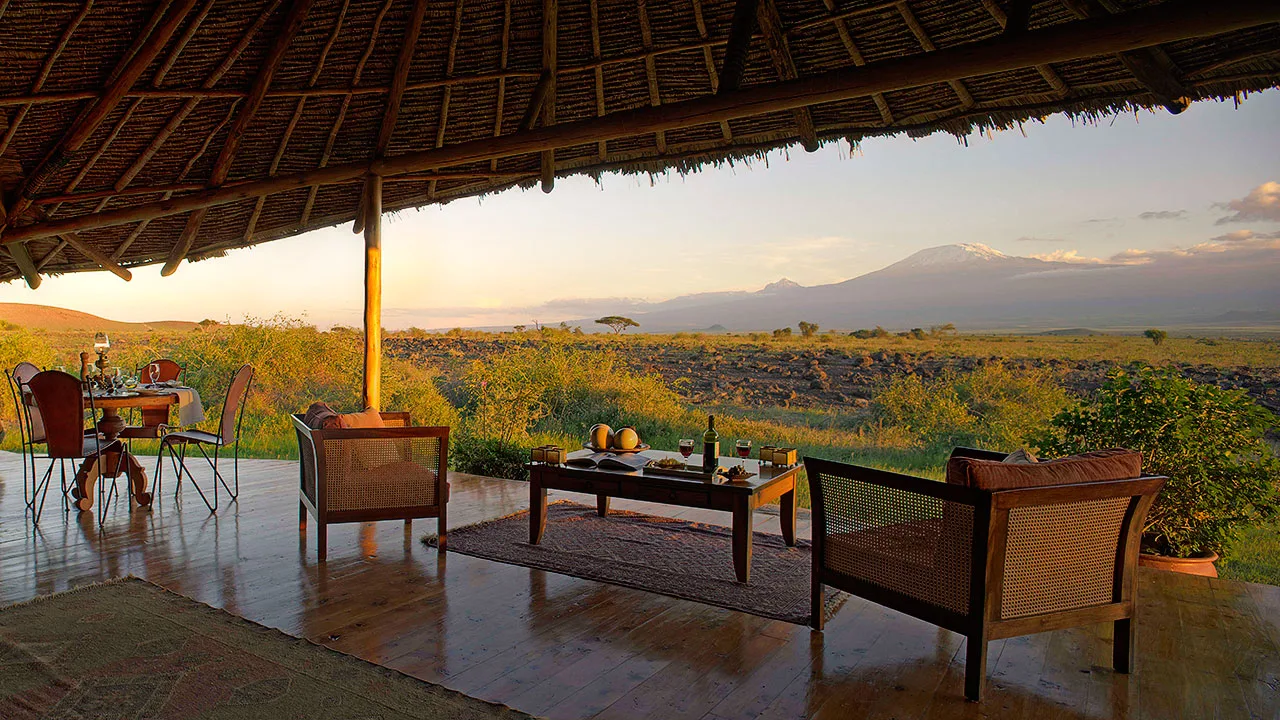 Sundowner hour on the open-air lounge deck, with the savanna stretching to the horizon.