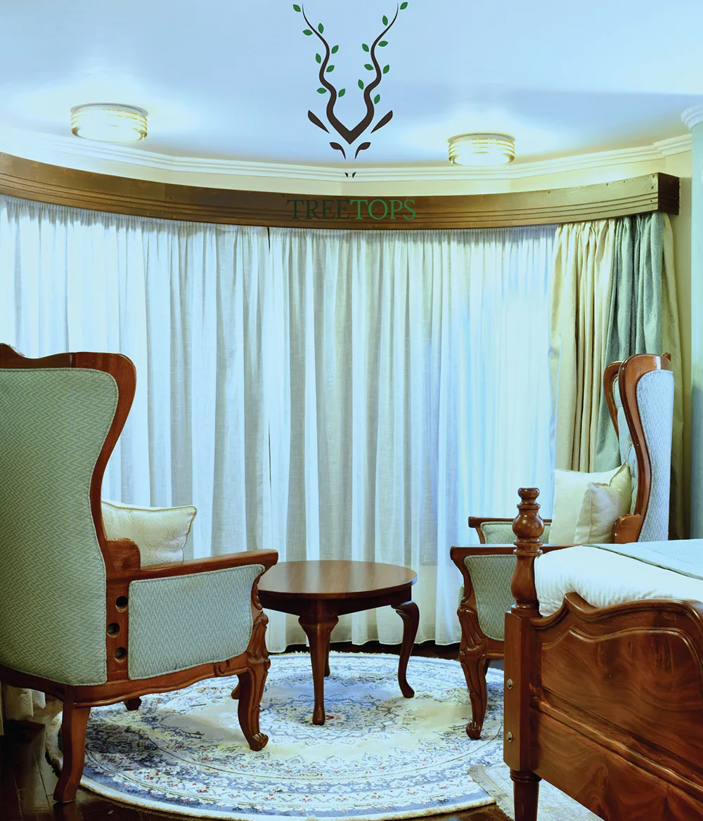 A quiet sitting area furnished with antique-style armchairs inside the lodge.