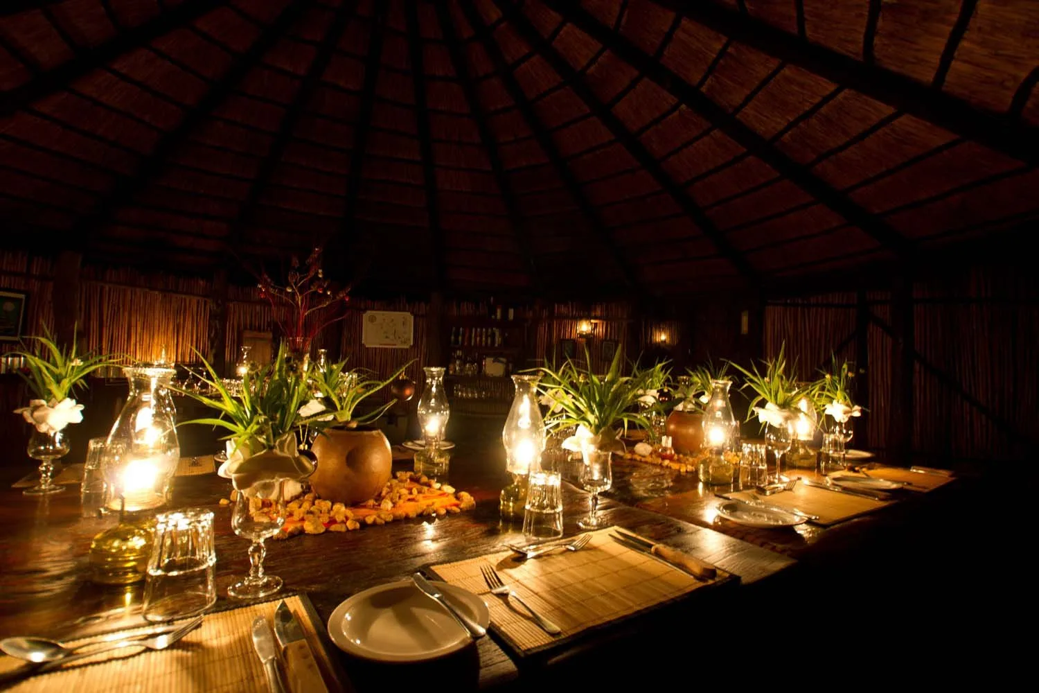 Candlelit dining in the camp's reed-and-thatch boma