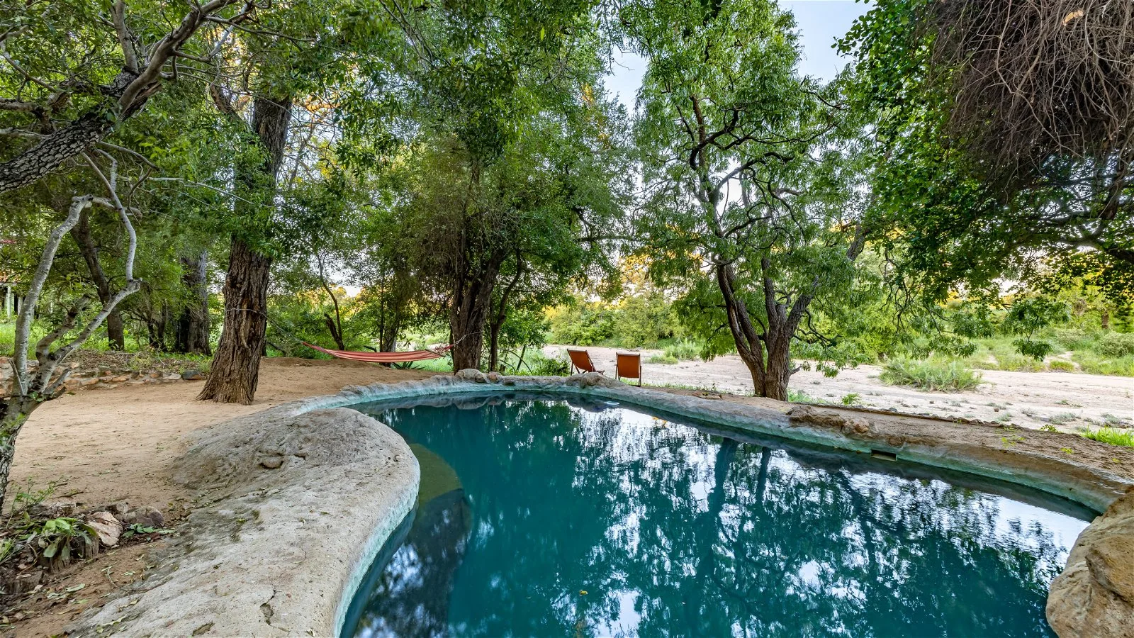 The camp's natural rock plunge pool, a shaded spot to relax between game drives