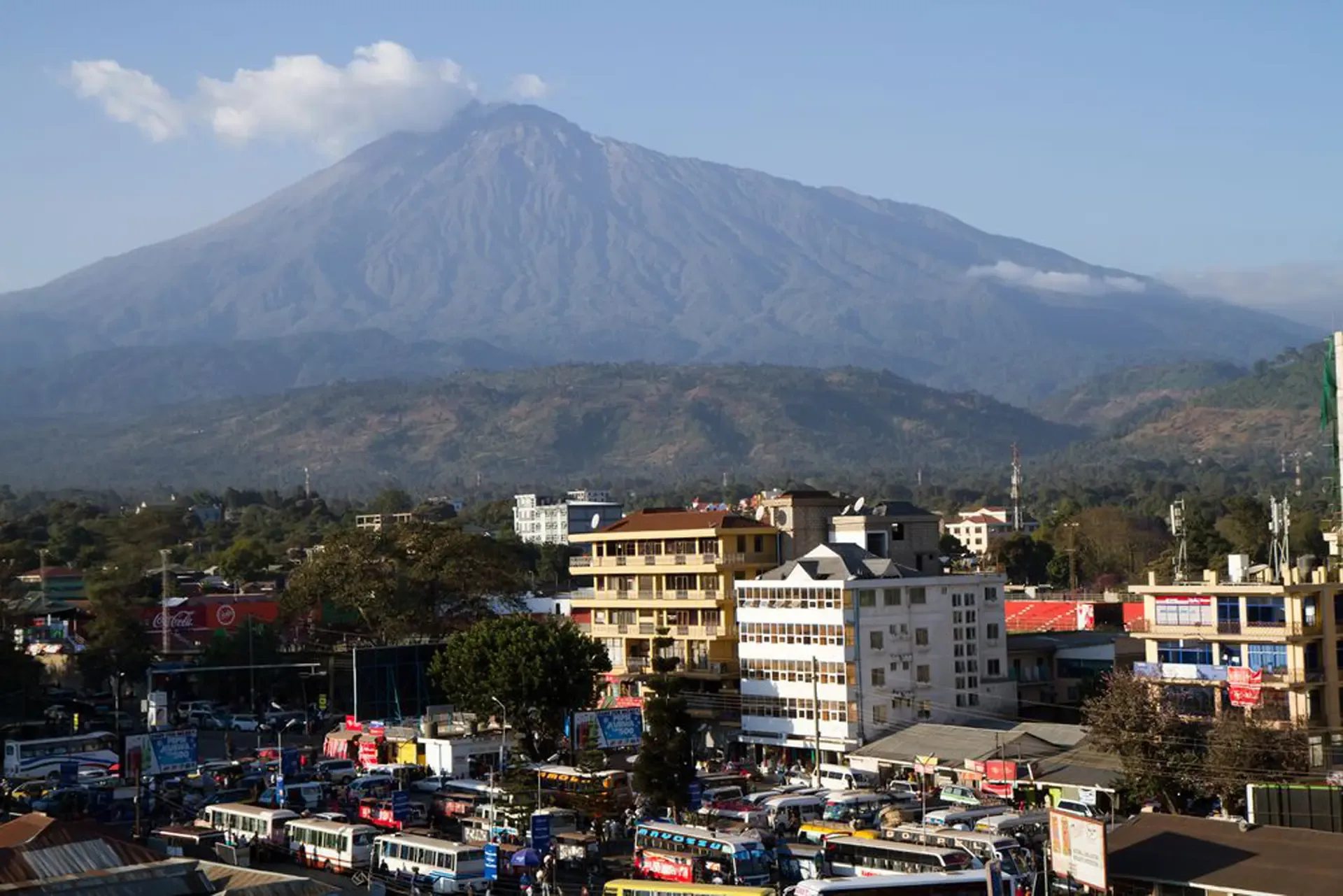Morning light over Arusha, with Mount Kilimanjaro rising beyond the town.