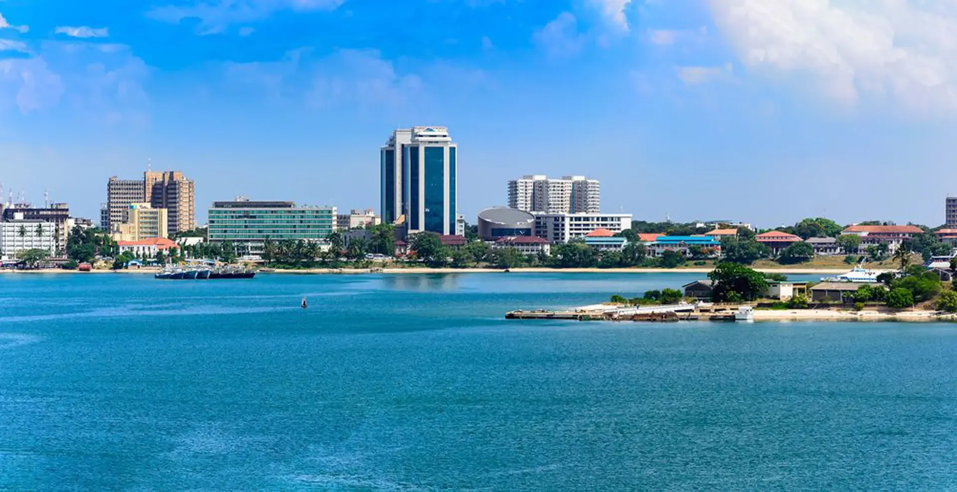Arrival day in Arusha, Tanzania, with the city skyline rising beyond the harbour.