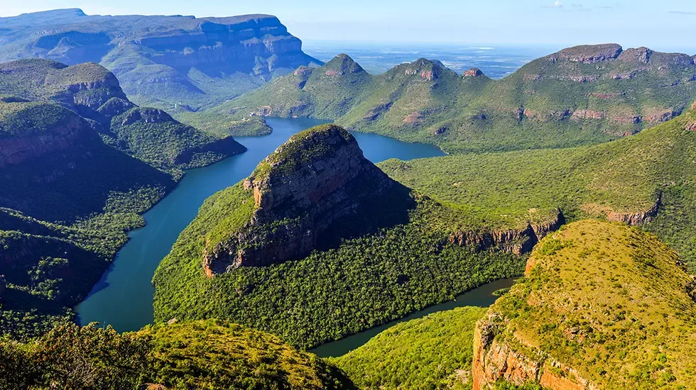 The Blyde River winds between green peaks in Blyde River Canyon Nature Reserve, South Africa.