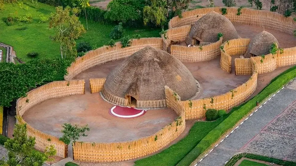 Traditional thatched huts within woven reed enclosures at the King's Palace in Nyanza, Rwanda.