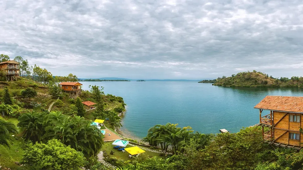 Wooden lodges and green terraces above the calm waters of Lake Kivu at Cyangugu, Rwanda.