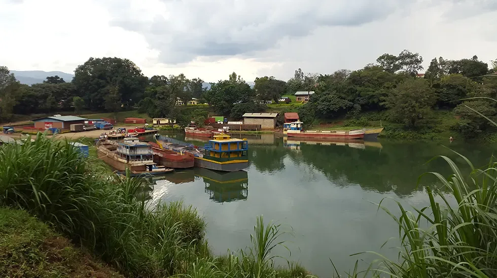 Boats moored on the calm water at Cyangugu, Rwanda, beneath a cloudy sky.
