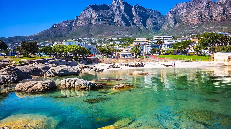 Clear tidal water and granite boulders below Table Mountain in Cape Town.