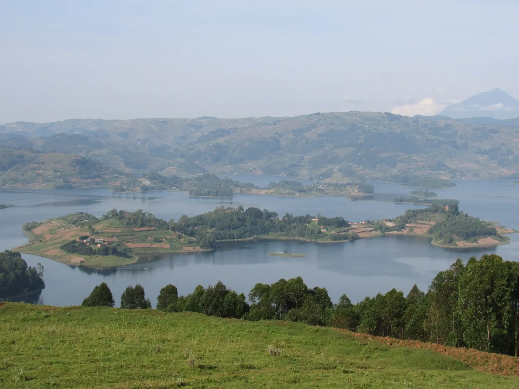 Gatatu, Uganda: green hills and lake islands seen from a grassy ridge.