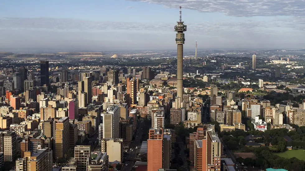 Morning light over the dense city skyline of Johannesburg, South Africa.